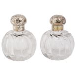 A pair of late Victorian silver topped cut glass scent bottles