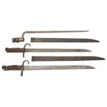 A triangular socket bayonet and two Japanese Type 30 bayonets and scabbards