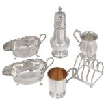 A collection of silver to include a pair of sauce boats, two christening mug and a toast rack