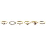 A full hoop diamond-set eternity band together with five other rings