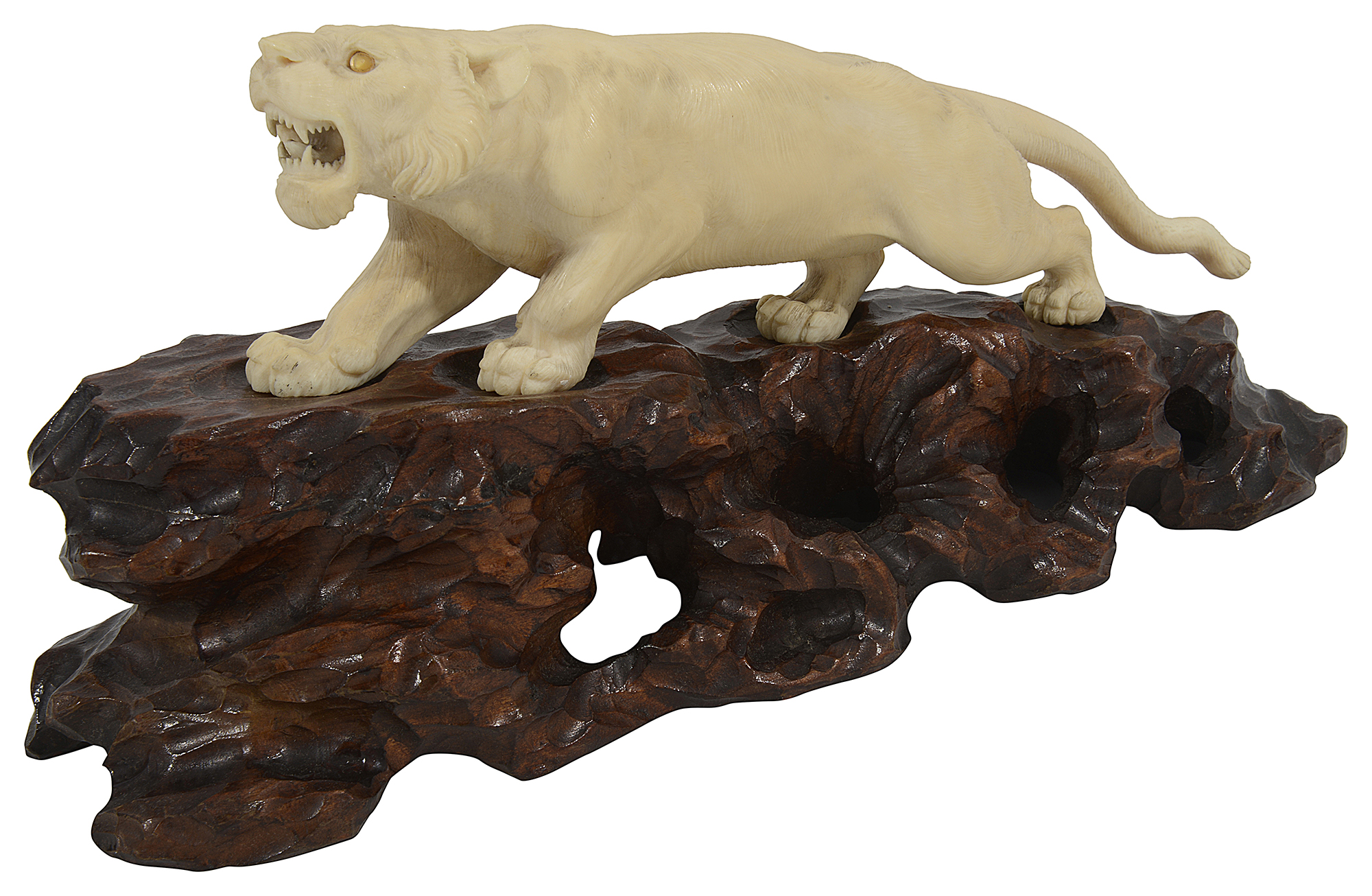 A Japanese Meiji period ivory okimono of a lioness