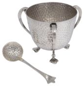 An Edwardian Arts & Crafts three handled sugar bowl and matching spoon