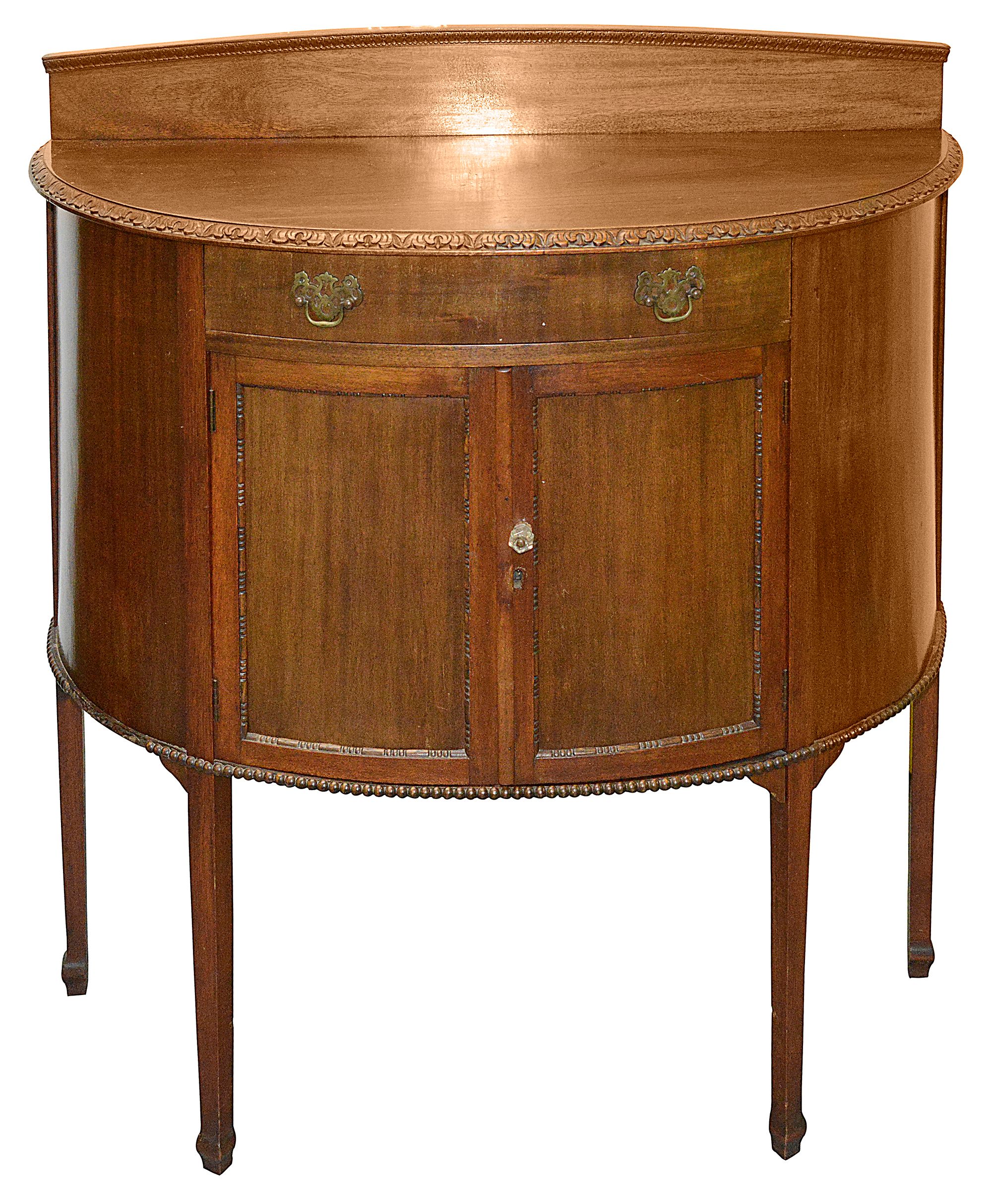 An Edwardian mahogany demi lune side cabinet