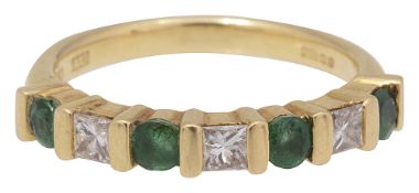 An emerald and diamond half hoop ring