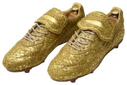A pair of limited edition Alexander McQueen 'golden' football boots