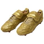 A pair of limited edition Alexander McQueen 'golden' football boots