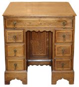 A George II oak and fruitwood crossbanded kneehole desk