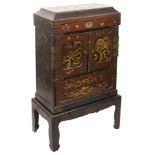 A Japanese Meiji period gilt decorated lacquer kodansu or table cabinet on stand