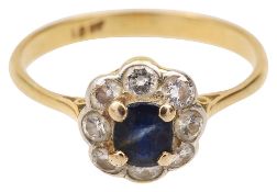 An oval sapphire and brilliant-cut diamond-set cluster ring