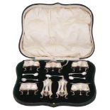 An Edwardian cased Art Nouveau silver seven piece cruet set