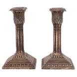 A pair of late Victorian silver dwarf candlesticks