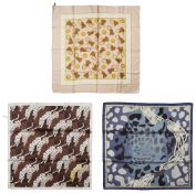 A collection of three designer scarves, including; Burberry and Cartier