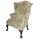 A George III mahogany wingback upholstered armchair
