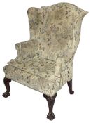A George III mahogany wingback upholstered armchair