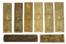 A set of seven closed trellis brass door fingers plates and two others