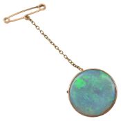 A circular opal brooch
