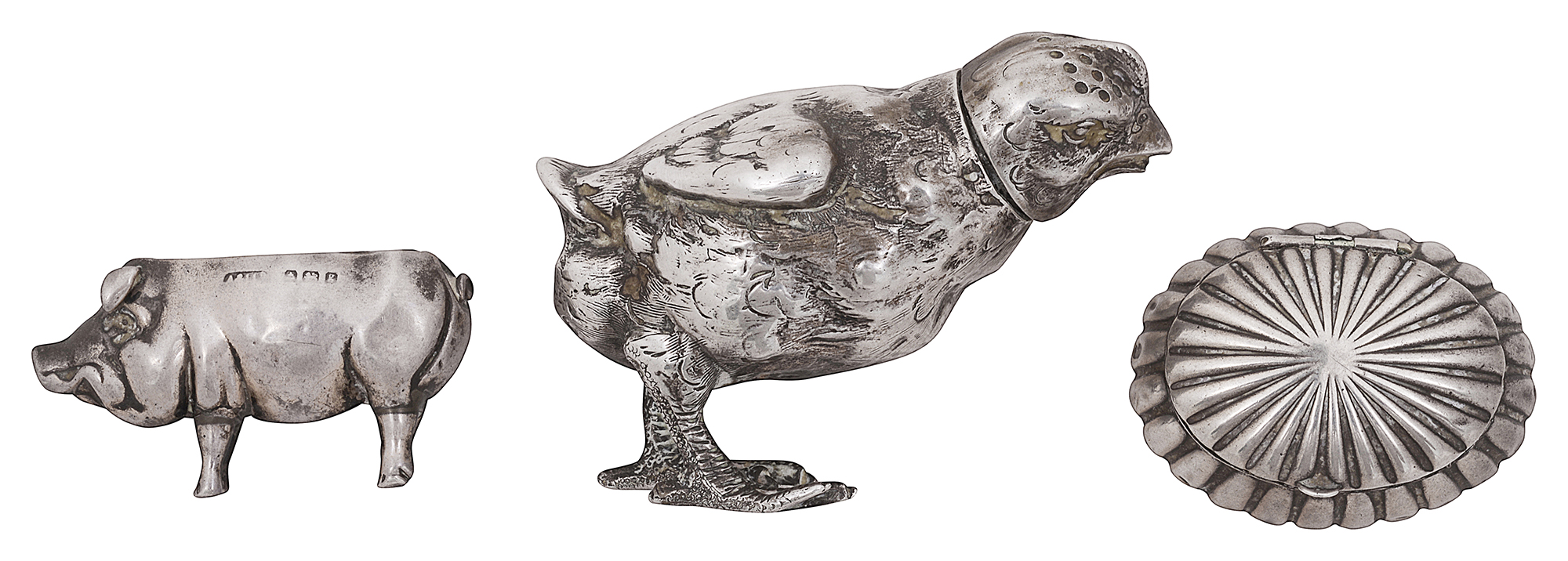 A German novelty .800 naturalistic silver chick pepper pot, an Edwardian novelty pig pincushion and