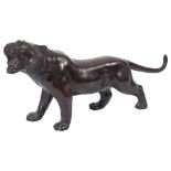 A Japanese Meiji period patinated bronze figure of a stalking tiger