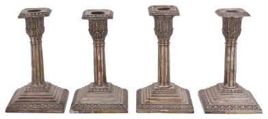 A set of four late Victorian silver dwarf candlesticks