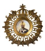 Bhupinder Singh of Patiala. An early 20th Century silver-gilt and enamel turban badge