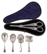 A pair of Victorian silver grape shears and four George III and later caddy spoons