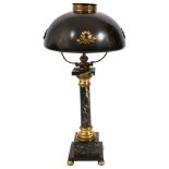 An early 20th century French Empire style lamp with domed tole shade