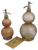 A large Edwardian British Syphon Co. soda syphon and a smaller syphon