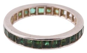 An emerald full hoop eternity ring