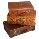 Two Edwardian crocodile embossed leather suitcases and a Chinese rattan suitcase