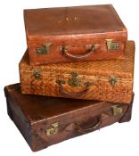 Two Edwardian crocodile embossed leather suitcases and a Chinese rattan suitcase
