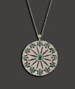 An early 20th century emerald and diamond-set circular brooch/ pendant