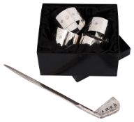 A set of four modern silver napkin rings and a novelty golf club letter opener