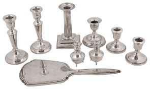 A collection of silver to include assorted dwarf candlesticks with weighted bases, a pair of George
