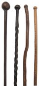 Two Southern African tribal hardwood knobkerries and two walking sticks