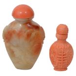 A Chinese carved coral snuff bottle and stopper and a russet celadon jade snuff bottle and stopper