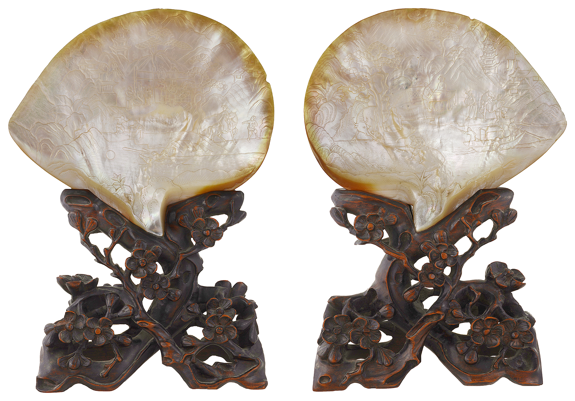 A late 19th century pair of Chinese Canton carved mother of pearl shells on hard wood stands