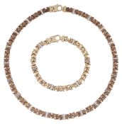 A 9ct three coloured gold fancy link necklace and matching bracelet