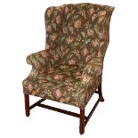 A George III mahogany and upholstered wing back armchair