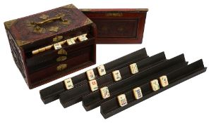 An early 20th century Chinese carved rosewood cased Pung Wo mahjong set