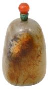 A Chinese pale celadon and russet jade 'pebble' snuff bottle and stopper