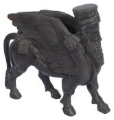A Grand Tour black figure of an Assyrian human headed winged bull Lamassu