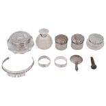 An Edwardian silver topped cut glass scent bottle, silver topped glass jars and other items