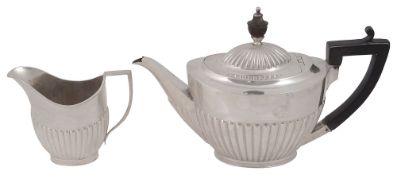 An Edwardian silver teapot and cream jug