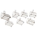 Seven George V silver arched toast racks