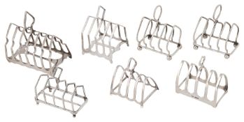 Seven George V silver arched toast racks