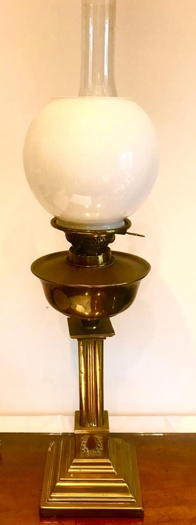 BRASS OIL LAMP UPON SQUARE COLUMN SUPPORT AND BASE, APPROXIMATELY 71cm HIGH INCLUDING GLOBE AND