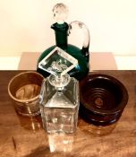 TWO DECANTERS AND TWO WOODEN COASTERS