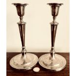 PAIR OF SILVER CANDLESTICKS WITH CIRCULAR BASE, CANDLESTICKS ARE FILLED