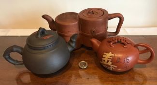 THREE JAPANESE TERRACOTTA TEAPOTS, TWO WITH CHARACTER MARKS TO BASE
