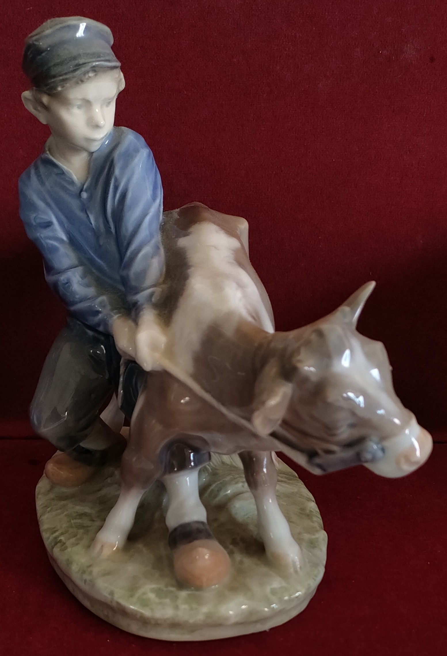 ROYAL COPENHAGEN GLAZED CERAMIC FIGURE DEPICTING A BOY WITH CALF REASONABLE, USED CONDITION